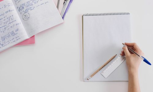 anonymous-student-posing-with-notepads
