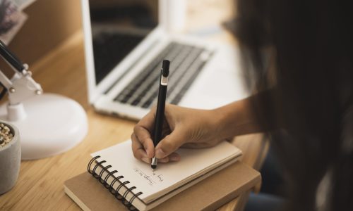 close-up-hand-writing-notebook