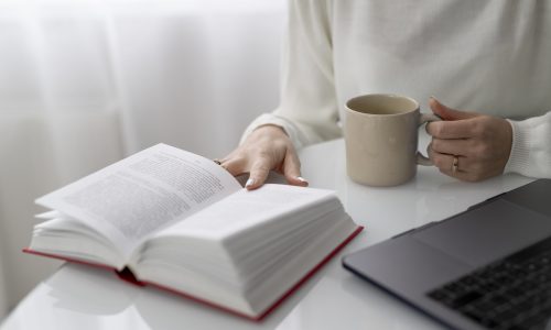 close-up-hands-holding-book-cup