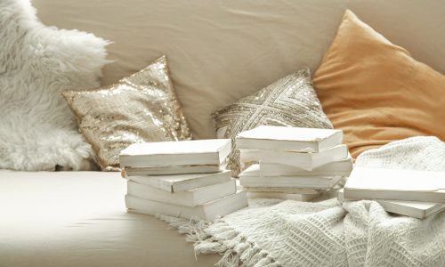 Cozy home atmosphere with books in the interior of the room. The concept of hobby and education.