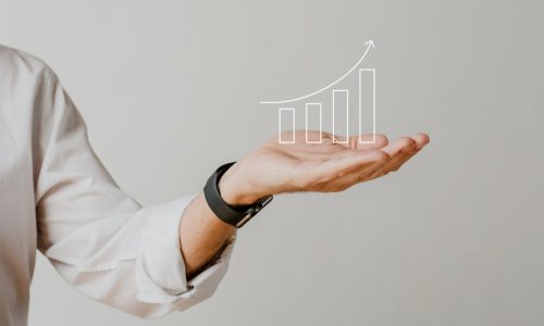 Digital increasing bar graph with businessman hand overlay