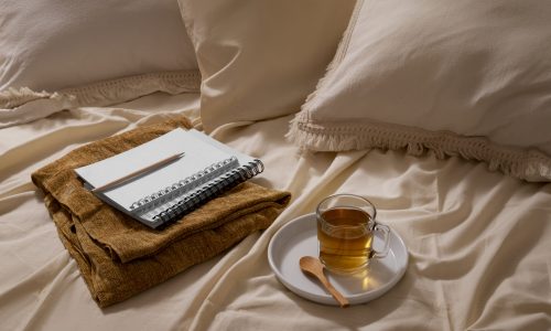 high-angle-cozy-bed-arrangement-with-tea