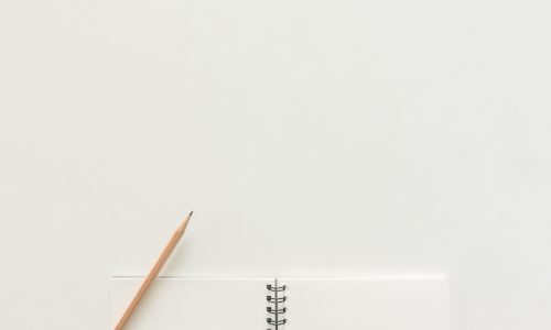 Minimal work space - Creative flat lay photo of workspace desk with sketchbook and wooden pencil on copy space white background. Top view , flat lay photography.