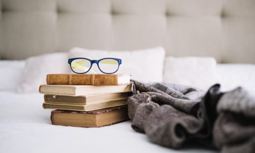old-books-glasses-near-blanket