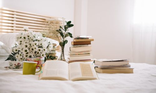 stack-books-flowers-bed