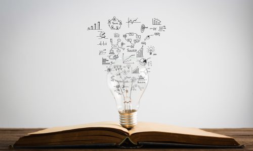Book and light bulb of business concept